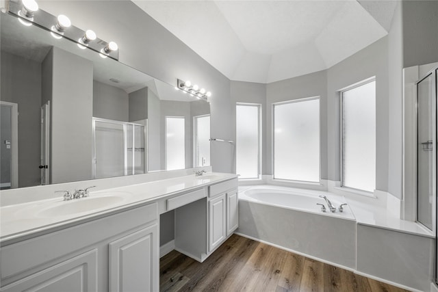 24910 Crystal Stone Ln, Katy, TX 77494 - bathroom with a stall shower, a bath, double vanity, and wood finished floors