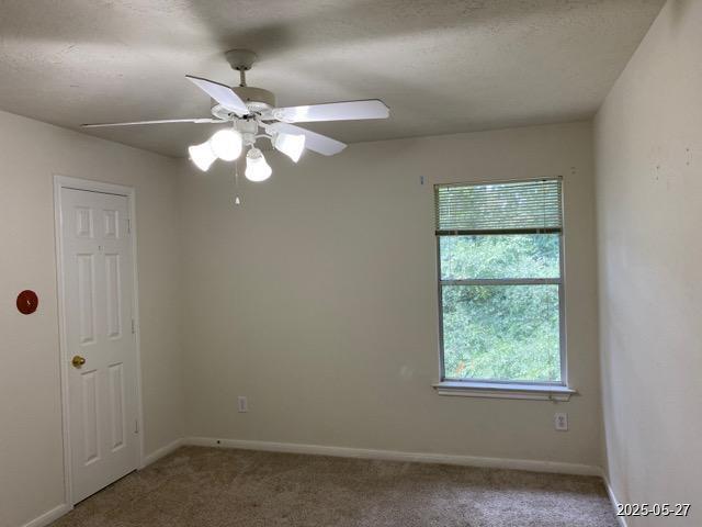 151 Prairie Dawn Cir, Conroe, TX 77385 - carpeted empty room with a ceiling fan and baseboards