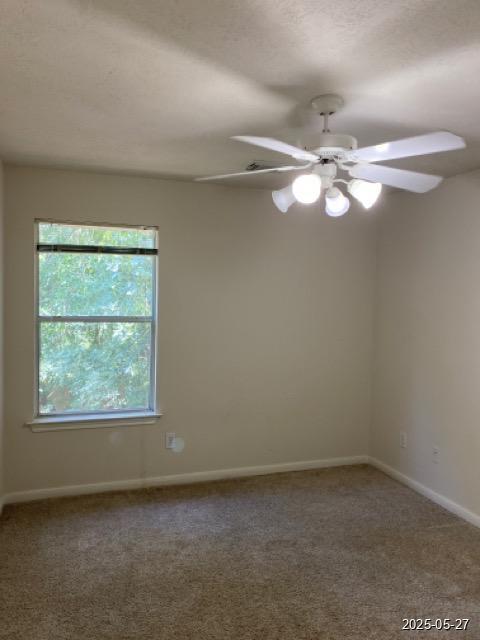 151 Prairie Dawn Cir, Conroe, TX 77385 - unfurnished room with carpet floors, a ceiling fan, and baseboards