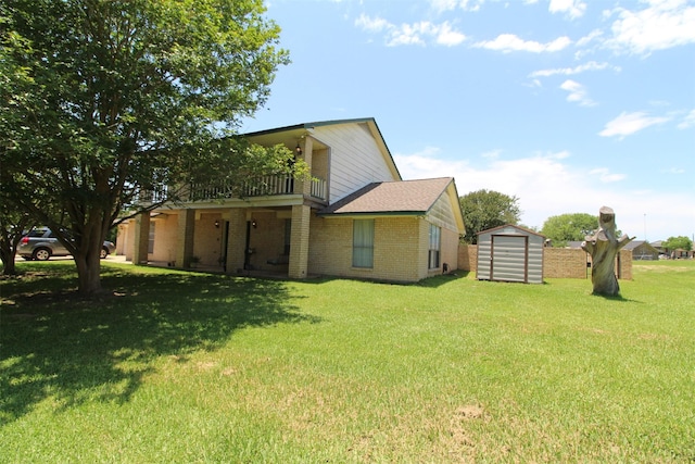 32226 Divot Dr, Waller, TX 77484 - view of side of home with a storage shed, a balcony, brick siding, and a yard
