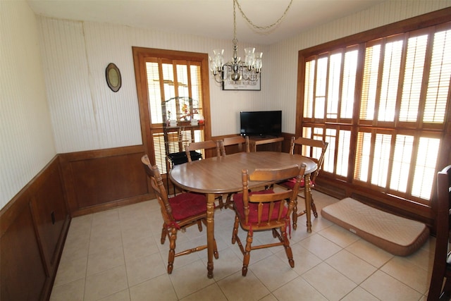 32226 Divot Dr, Waller, TX 77484 - dining room with plenty of natural light, a chandelier, wallpapered walls, a wainscoted wall, and light tile patterned floors