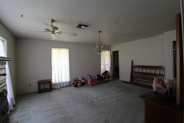 32226 Divot Dr, Waller, TX 77484 - unfurnished living room with plenty of natural light, light colored carpet, a chandelier, and a ceiling fan
