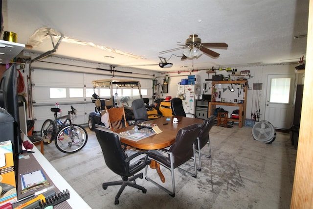 32226 Divot Dr, Waller, TX 77484 - garage featuring white fridge with ice dispenser, a garage door opener, and ceiling fan