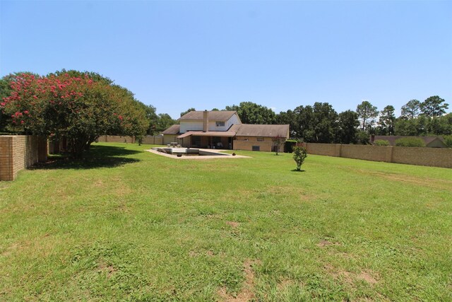 32226 Divot Dr, Waller, TX 77484 - fenced backyard with a patio
