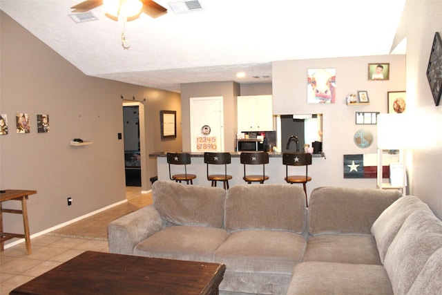 9807 Sparrow St, La Porte, TX 77571 - living room featuring light tile patterned floors, a ceiling fan, and baseboards