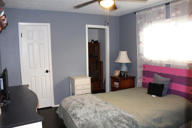9807 Sparrow St, La Porte, TX 77571 - bedroom with dark wood finished floors and a ceiling fan