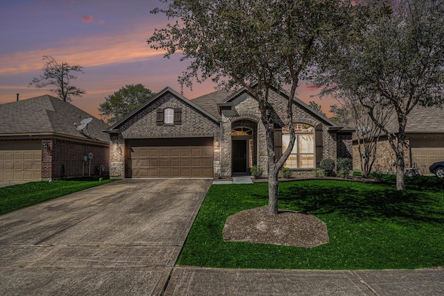 6843 Oaken Gate Way, Humble, TX 77338 - french provincial home with driveway, a yard, a garage, stone siding, and brick siding