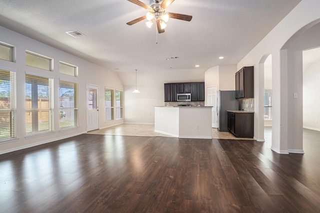 6843 Oaken Gate Way, Humble, TX 77338 - unfurnished living room with wood finished floors, arched walkways, ceiling fan, and recessed lighting