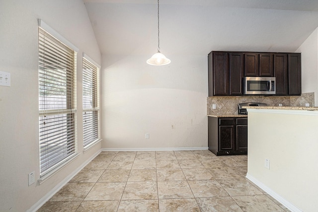 6843 Oaken Gate Way, Humble, TX 77338 - kitchen with stainless steel microwave, vaulted ceiling, plenty of natural light, dark brown cabinetry, and backsplash