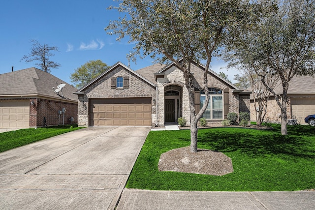 6843 Oaken Gate Way, Humble, TX 77338 - french provincial home featuring a garage, a front yard, driveway, brick siding, and stone siding