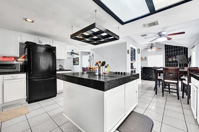 11703 Teaneck Dr, Houston, TX 77089 - kitchen featuring ceiling fan, black appliances, light tile patterned floors, dark countertops, and lofted ceiling
