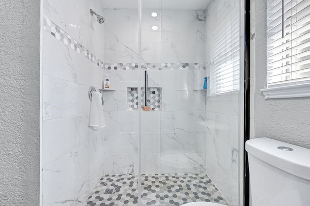 11703 Teaneck Dr, Houston, TX 77089 - bathroom with toilet, a shower stall, and a textured wall