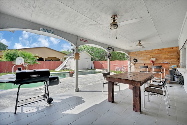 11703 Teaneck Dr, Houston, TX 77089 - fenced backyard featuring a ceiling fan, outdoor dining space, and a patio