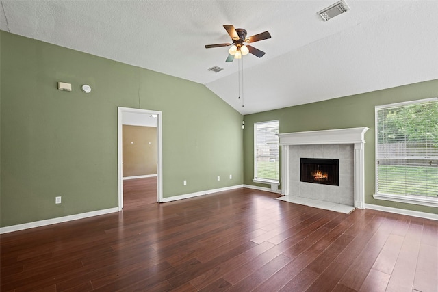 21055 Southern Colony Ct, Katy, TX 77449 - unfurnished living room featuring lofted ceiling, ceiling fan, a tile fireplace, healthy amount of natural light, and wood finished floors