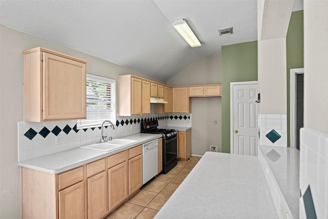 21055 Southern Colony Ct, Katy, TX 77449 - kitchen featuring light brown cabinets, range with gas stovetop, dishwasher, under cabinet range hood, and vaulted ceiling