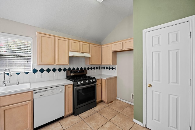 21055 Southern Colony Ct, Katy, TX 77449 - kitchen featuring white dishwasher, gas range, light brown cabinetry, under cabinet range hood, and vaulted ceiling