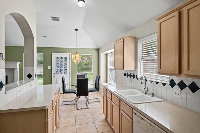 21055 Southern Colony Ct, Katy, TX 77449 - kitchen with vaulted ceiling, light countertops, light tile patterned floors, decorative backsplash, and hanging light fixtures