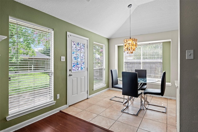 21055 Southern Colony Ct, Katy, TX 77449 - dining room with a chandelier, lofted ceiling, a textured ceiling, and a textured wall