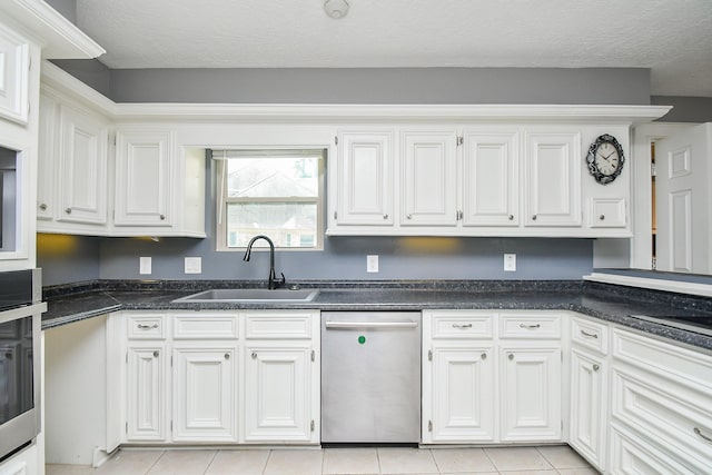 12903 Cluster Pine Dr, Cypress, TX 77429 - kitchen featuring appliances with stainless steel finishes, white cabinets, dark countertops, and light tile patterned floors