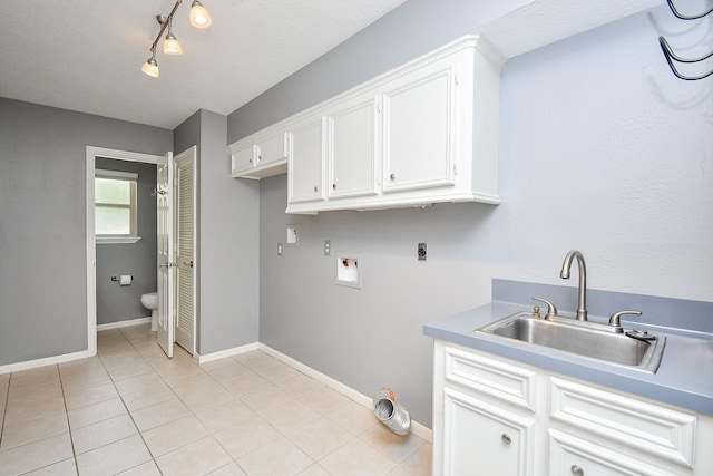12903 Cluster Pine Dr, Cypress, TX 77429 - laundry area with washer hookup, light tile patterned floors, cabinet space, and electric dryer hookup