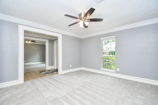 12903 Cluster Pine Dr, Cypress, TX 77429 - spare room featuring carpet, ornamental molding, ceiling fan, a textured ceiling, and tile patterned floors