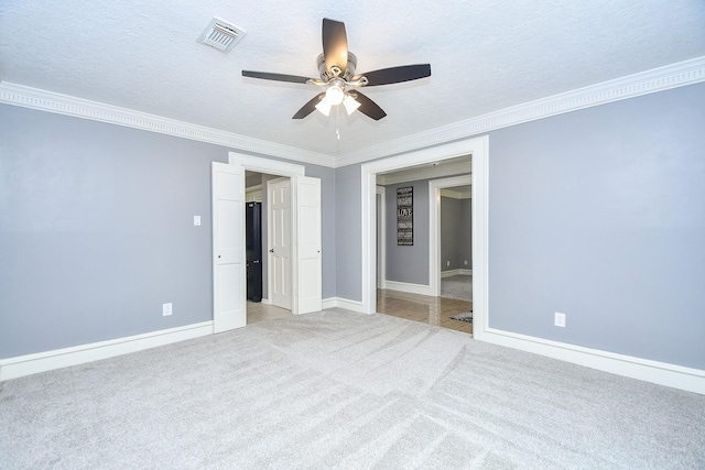 12903 Cluster Pine Dr, Cypress, TX 77429 - unfurnished bedroom featuring carpet, ornamental molding, ceiling fan, and a textured ceiling
