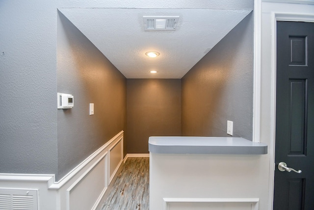 12903 Cluster Pine Dr, Cypress, TX 77429 - hallway with wood finished floors, a textured wall, and a textured ceiling