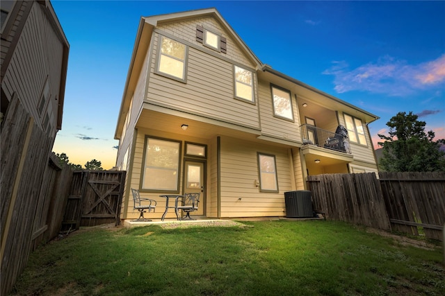 122 Cheswood Forest Dr, Montgomery, TX 77316 - back of property at dusk featuring a fenced backyard and a balcony