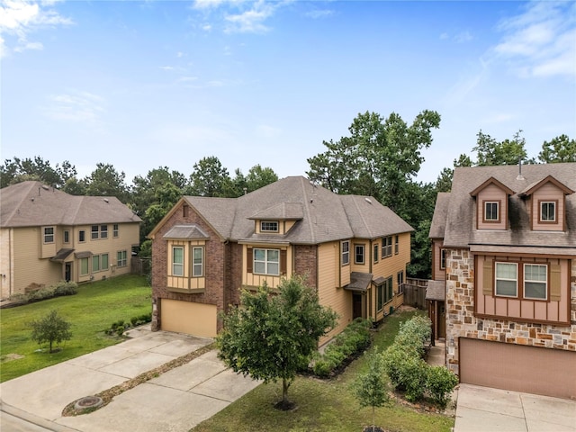 122 Cheswood Forest Dr, Montgomery, TX 77316 - view of front of house featuring an attached garage, driveway, stone siding, and a front lawn