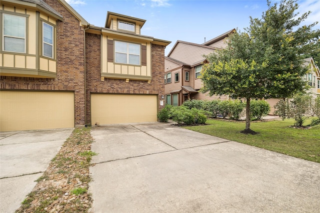 122 Cheswood Forest Dr, Montgomery, TX 77316 - view of front facade featuring concrete driveway, an attached garage, brick siding, and a front yard