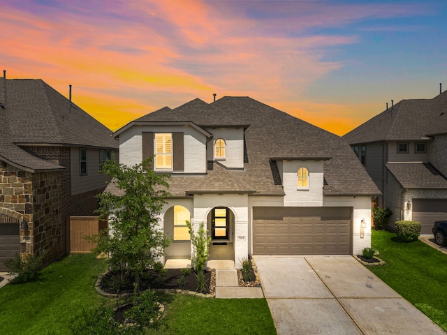 15610 Scolty Reach Ln, Humble, TX 77346 - french provincial home featuring concrete driveway, roof with shingles, brick siding, and a garage