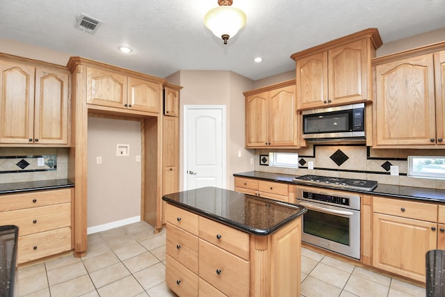 1019 N Country Club Dr, La Porte, TX 77571 - kitchen featuring stainless steel appliances, light brown cabinetry, backsplash, light tile patterned floors, and recessed lighting