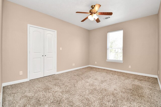1019 N Country Club Dr, La Porte, TX 77571 - unfurnished bedroom featuring carpet, a closet, and ceiling fan