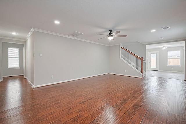 6723 Green Pear Ln, Houston, TX 77049 - unfurnished living room with stairway, ceiling fan, crown molding, dark wood-type flooring, and recessed lighting