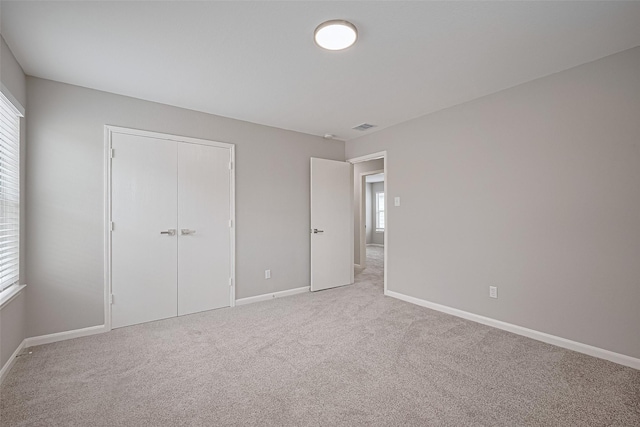 6723 Green Pear Ln, Houston, TX 77049 - unfurnished bedroom with multiple windows, light colored carpet, and a closet