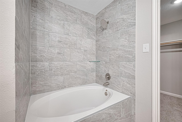 6723 Green Pear Ln, Houston, TX 77049 - bathroom with bathing tub / shower combination and a textured ceiling