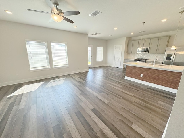 10654 Whitejacket, Conroe, TX 77385 - kitchen with appliances with stainless steel finishes, light countertops, gray cabinets, open floor plan, and baseboards