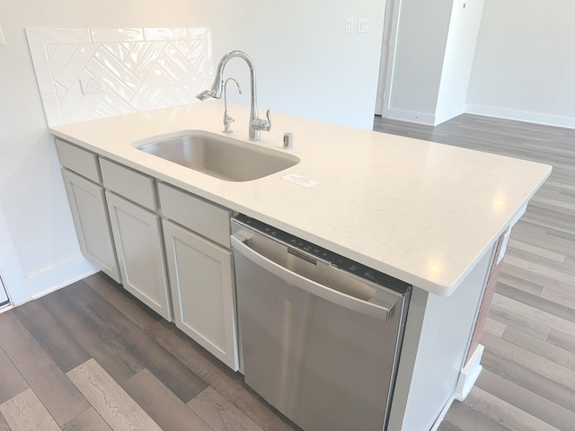10654 Whitejacket, Conroe, TX 77385 - kitchen with stainless steel dishwasher, a sink, dark wood-style flooring, and baseboards