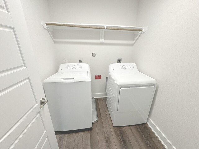 10654 Whitejacket, Conroe, TX 77385 - laundry room featuring washer and clothes dryer, dark wood-style flooring, and baseboards