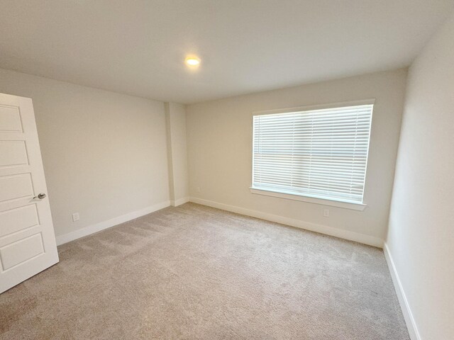 10654 Whitejacket, Conroe, TX 77385 - spare room featuring light colored carpet and baseboards