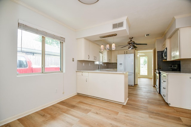 5651 Wigton Dr, Houston, TX 77096 - kitchen featuring range, white refrigerator with ice dispenser, stainless steel microwave, a sink, and crown molding