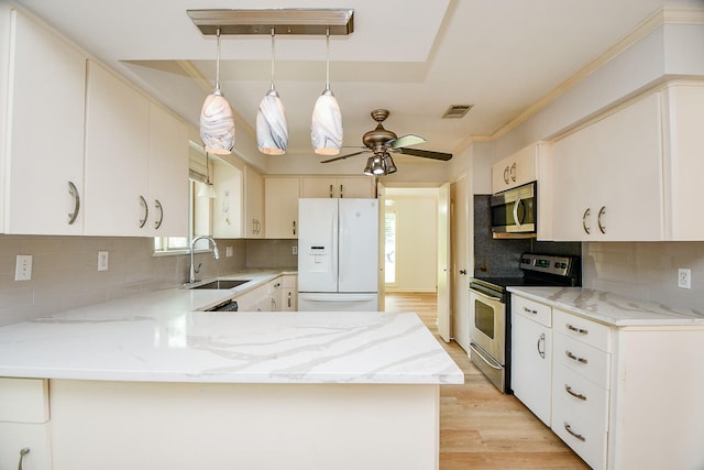 5651 Wigton Dr, Houston, TX 77096 - kitchen featuring stainless steel appliances, a sink, plenty of natural light, light wood finished floors, and ornamental molding