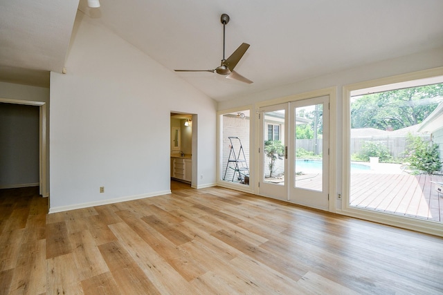 5651 Wigton Dr, Houston, TX 77096 - empty room with a ceiling fan, light wood-style floors, high vaulted ceiling, and baseboards