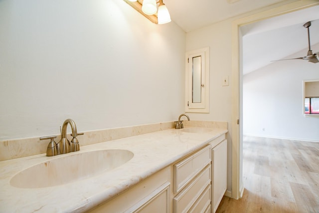 5651 Wigton Dr, Houston, TX 77096 - bathroom featuring double vanity, wood finished floors, lofted ceiling, and a ceiling fan