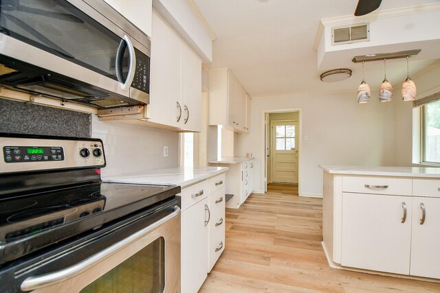 5651 Wigton Dr, Houston, TX 77096 - kitchen featuring appliances with stainless steel finishes, light countertops, backsplash, and white cabinetry