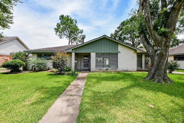 5651 Wigton Dr, Houston, TX 77096 - view of front of home featuring brick siding and a front lawn