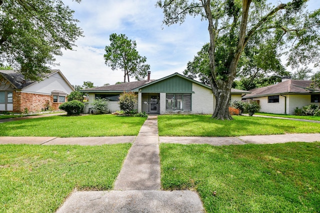 5651 Wigton Dr, Houston, TX 77096 - mid-century inspired home with a front yard and brick siding