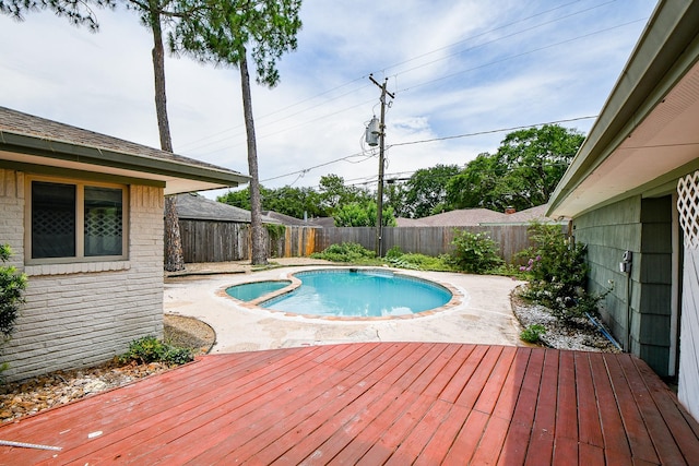 5651 Wigton Dr, Houston, TX 77096 - view of swimming pool featuring a deck, a fenced backyard, a pool with connected hot tub, and a patio