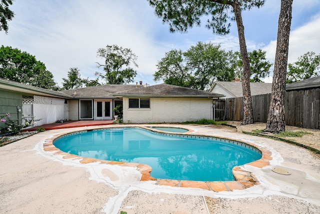 5651 Wigton Dr, Houston, TX 77096 - view of pool featuring french doors, an in-ground hot tub, a fenced backyard, and a patio area