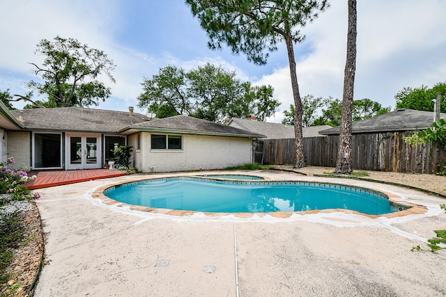 5651 Wigton Dr, Houston, TX 77096 - view of pool with french doors, an in-ground hot tub, a fenced backyard, a deck, and a patio area